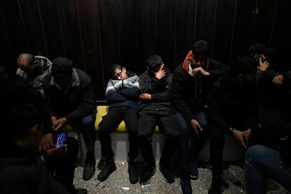 Family members waiting for the release of Palestinian prisoners follow developments early Sunday, Feb. 23, 2025, after receiving news that Israel has delayed the release of hundreds of Palestinian prisoners scheduled for Saturday, in the West Bank city of Ramallah. (AP Photo/Nasser Nasser)