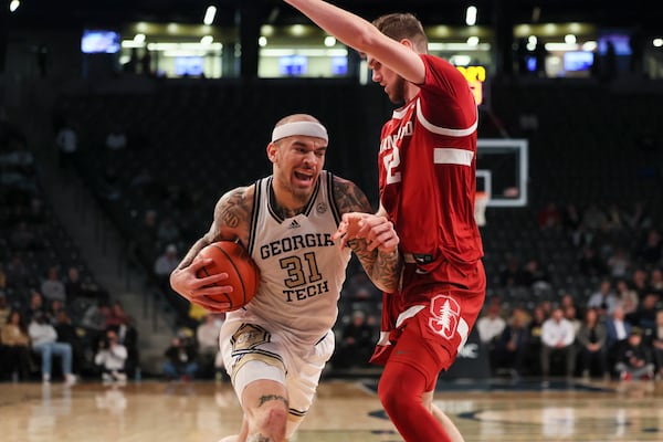 Georgia Tech forward Duncan Powell (31) drives against Stanford forward Aidan Cammann (52) during the first half at McCamish Pavilion, Wednesday, February, 12, 2024, in Atlanta. (Jason Getz / AJC)