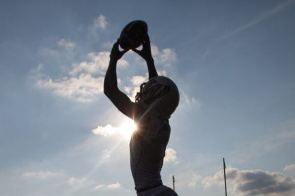 silhouette of player catching football