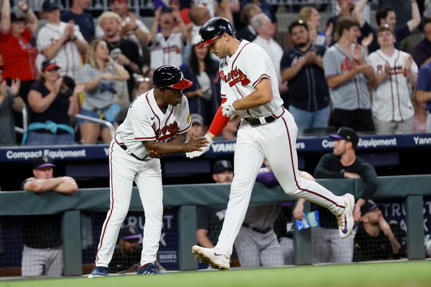 Braves third base coach Ron Washington shakes hands with Matt Olson (28) after Olson hit a solo home run during the bottom of the seventh inning. Miguel Martinez / miguel.martinezjimenez@ajc.com 