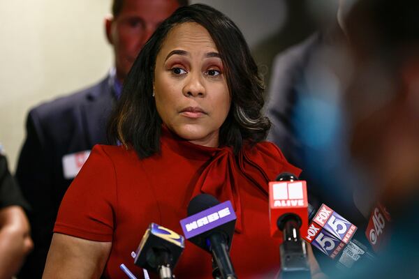 Surrounded by Fulton County law enforcement officials, District Attorney Fani Willis speaks during a news conference about the RICO indictment in the celebrity home invasion ring on Aug. 29, 2022. (Natrice Miller/Atlanta Journal-Constitution/TNS)