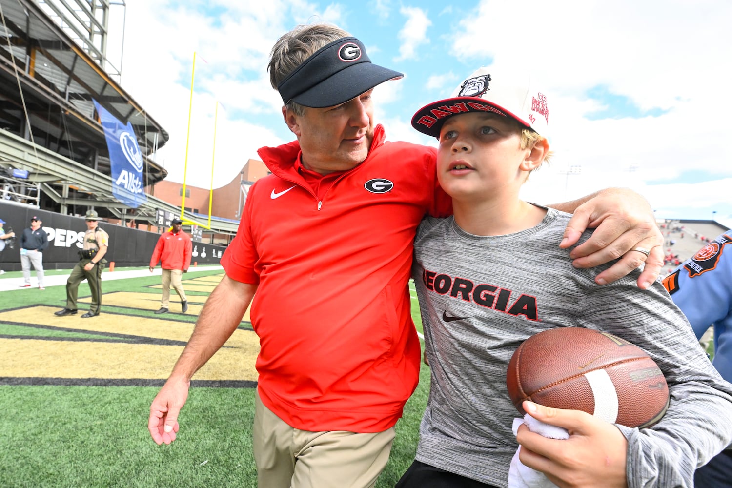 Georgia head coach Kirby Smart walks off the field with son Andrew after an NCAA football game against Vanderbilt, Saturday, Oct. 14, 2023, in Nashville, Tenn. Georgia won 37-20. (Special to the AJC/John Amis)