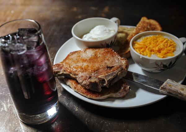 The Angus Brown breakfast with two pork chops, two poached eggs, cheese grits, a biscuit and grape soda. (Beckysteinphotography.com)