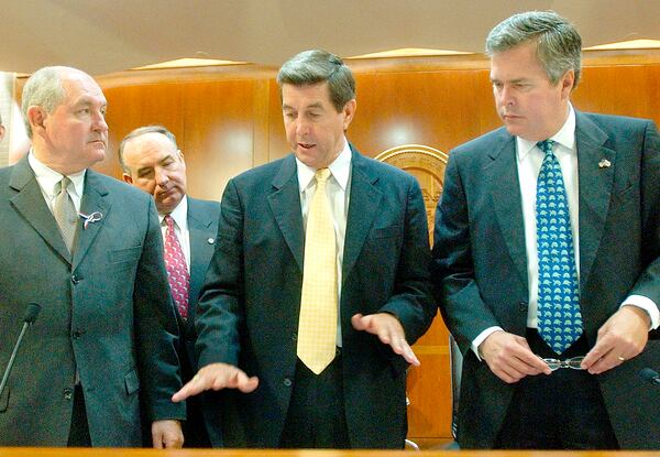 Alabama Gov. Bob Riley, center, explains a chart to Georgia Gov. Sonny Perdue, left, and Florida Gov. Jeb Bush, right, during a meeting of the Apalachicola-Chattahoochee-Flint River Basin Commission, Friday, May 16, 2003, in Tallahassee, Fla. Federal Commissioner Alec Poitevint, second from left, looks on. The commission met to discuss water rights issues from the three rivers that flow through each state.(AP Photo/Phil Coale)