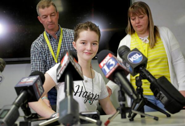 Deserae Turner, center, a Utah teenage girl who survived being shot in the head by two boys, arrives for a news conference with her parents Matt and April Turner, for the first time since she was found in a ditch two months ago Thursday, April 20, 2017, at Primary Children's Hospital, in Salt Lake City. The Feb. 17 crime shocked residents in the small town of Smithfield, a bedroom community near Logan. Authorities say the two teenage boys accused of shooting Turner concocted the plan while playing video games and discussing their desire to "get rid" of the girl who was texting one of them. (AP Photo/Rick Bowmer)