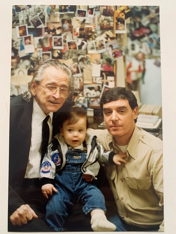 Howard Finster with his friend Rick Berman, who sold the folk artist's work at the Little 5 Points gallery he operated with his wife Jennie Ashcraft Berman. Immediately after this 1989 photo was taken with the Bermans' infant son Seth, Rick Berman accompanied Howard to New York for a major exhibition of his art. In their Big Apple hotel room, Howard composed a poem to Seth. This photo and the poem are included in the Callanwolde exhibition. 
(Courtesy of the Bermans)