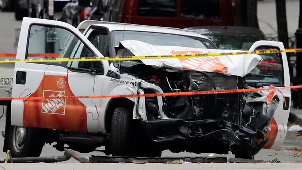 A damaged Home Depot truck remains on the scene Wednesday, Nov. 1, 2017, after the driver mowed down people on a riverfront bike path near the World Trade Center on Tuesday in New York. 