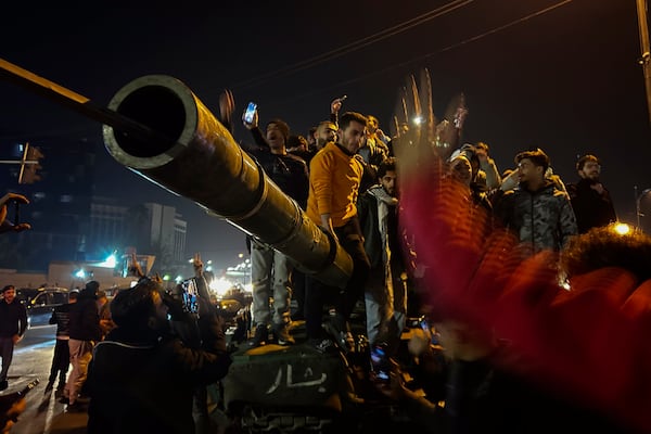 Syrians celebrate the arrival of opposition fighters in Damascus, Syria, Sunday Dec. 8, 2024. (AP Photo/Omar Sanadiki)