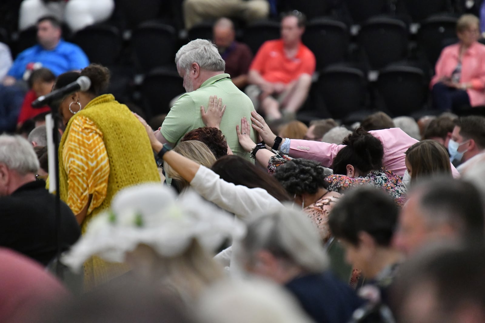 June 2, 2022  Athens - Delegates pray after they voted overwhelming to allow about 70 member churches to voluntarily leave the conference during the 2022 North Georgia Annual Conference at the Classic Center in Athens on Thursday, June 2, 2022. Delegates in the North Georgia Conference of the United Methodist Church voted overwhelming Thursday to allow about 70 member churches to voluntarily leave the conference as a result of their disagreement largely over the issue of full inclusion of the LGBTQ community. (Hyosub Shin / Hyosub.Shin@ajc.com)