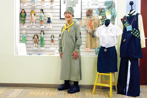 Girl Scout archivist Sue Belden displays old scouting badges. (Source: Donna P. Williams)