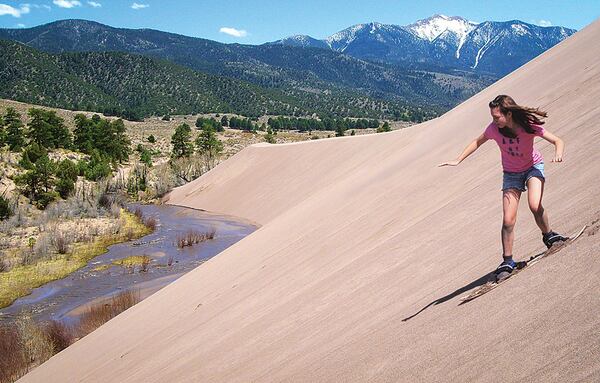 Sandboarders shred the dunes on the steep slopes above Medano Creek. CONTRIBUTED BY THERESE GUNDERSEN