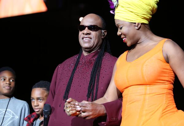 Nov. 22, 2014 ATLANTA: The legendary singer, musician, songwriter, Stevie Wonder, accompanied by two of his sons, is escorted on to the stage by Grammy Award winning singer, songwriter India Arie as he brings his tour celebrating his landmark album, "Songs in the Key of Life," to Atlanta, performing before a sold-out audience at the Philips Arena. (Akili-Casundria Ramsess/Special to the AJC) Wonder was led onstage by his two young songs and his guest vocalist Indie.Arie. Photo: Akili-Casundria Ramsess/Special to the AJC.