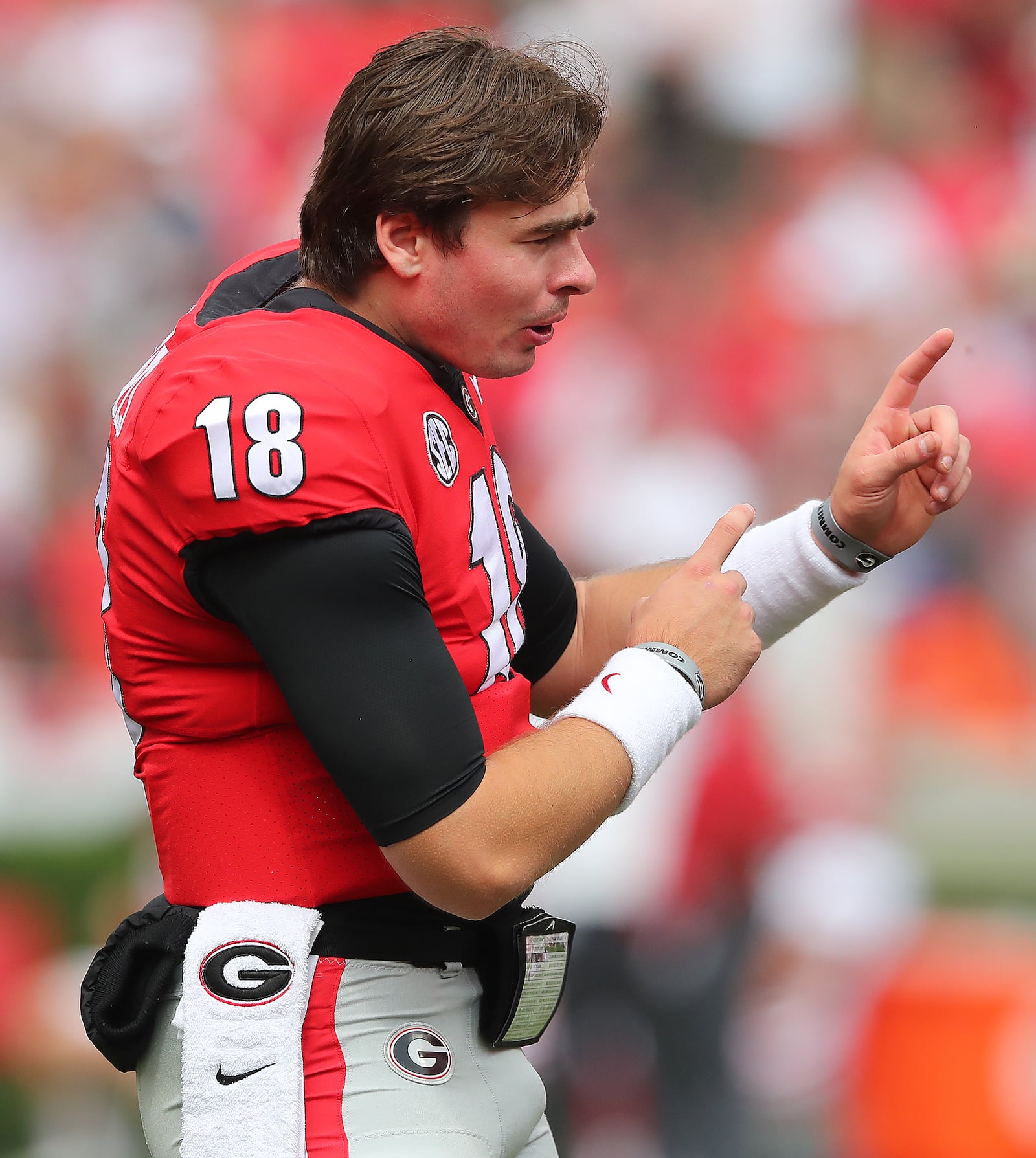 Georgia quarterback JT Daniels, who did not play in the game, helps from the sidelines against Arkansas during the first half Saturday, Oct. 2, 2021, in Athens. (Curtis Compton / Curtis.Compton@ajc.com)