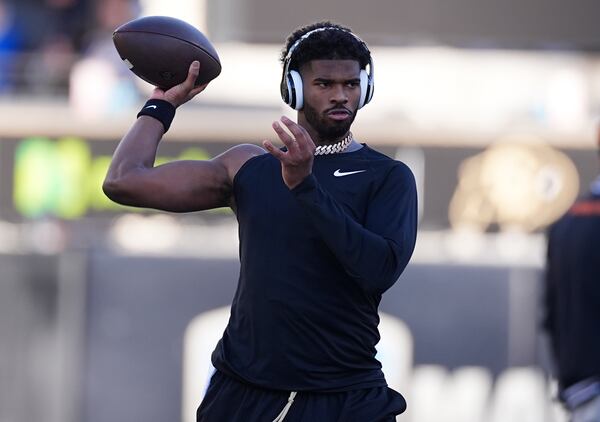 Colorado quarterback Shedeur Sanders warms up before an NCAA college football game against Oklahoma State Friday, Nov. 29, 2024, in Boulder, Colo. (AP Photo/David Zalubowski)