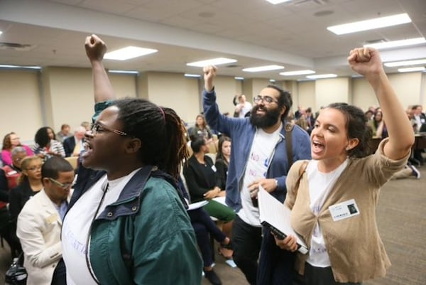 Students exit the Georgia Board of Regents after protesting a proposed vote on making Georgia Attorney General Sam Olens president of Kennesaw State University. BOB ANDRES/STAFF