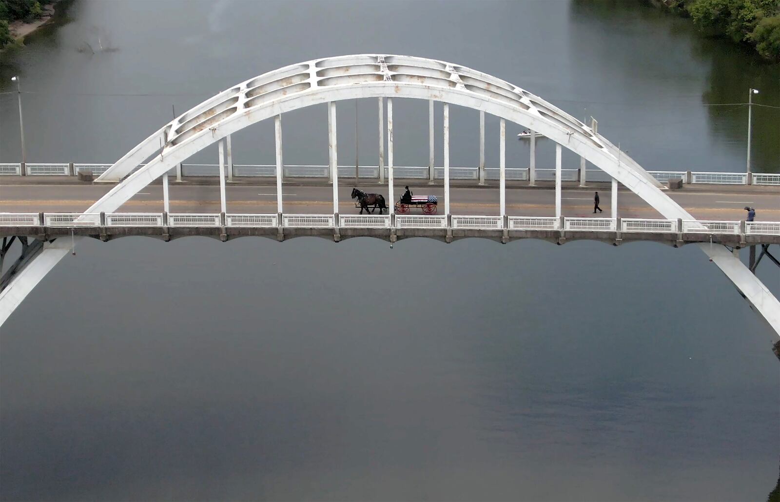 A horse-drawn caisson carries the body of Congressman John Lewis across the Edmund Pettus Bridge on July 26. (Hyosub Shin / Hyosub.Shin@ajc.com)