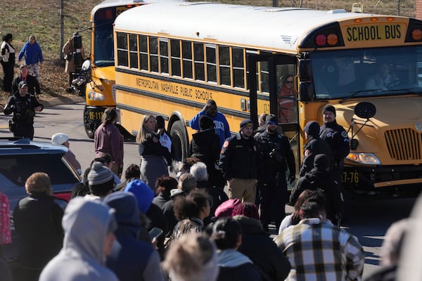 School buses arrive at a unification site following a shooting at Antioch High School in Nashville, Tenn., Wednesday, Jan. 22, 2025. (AP Photo/George Walker IV)