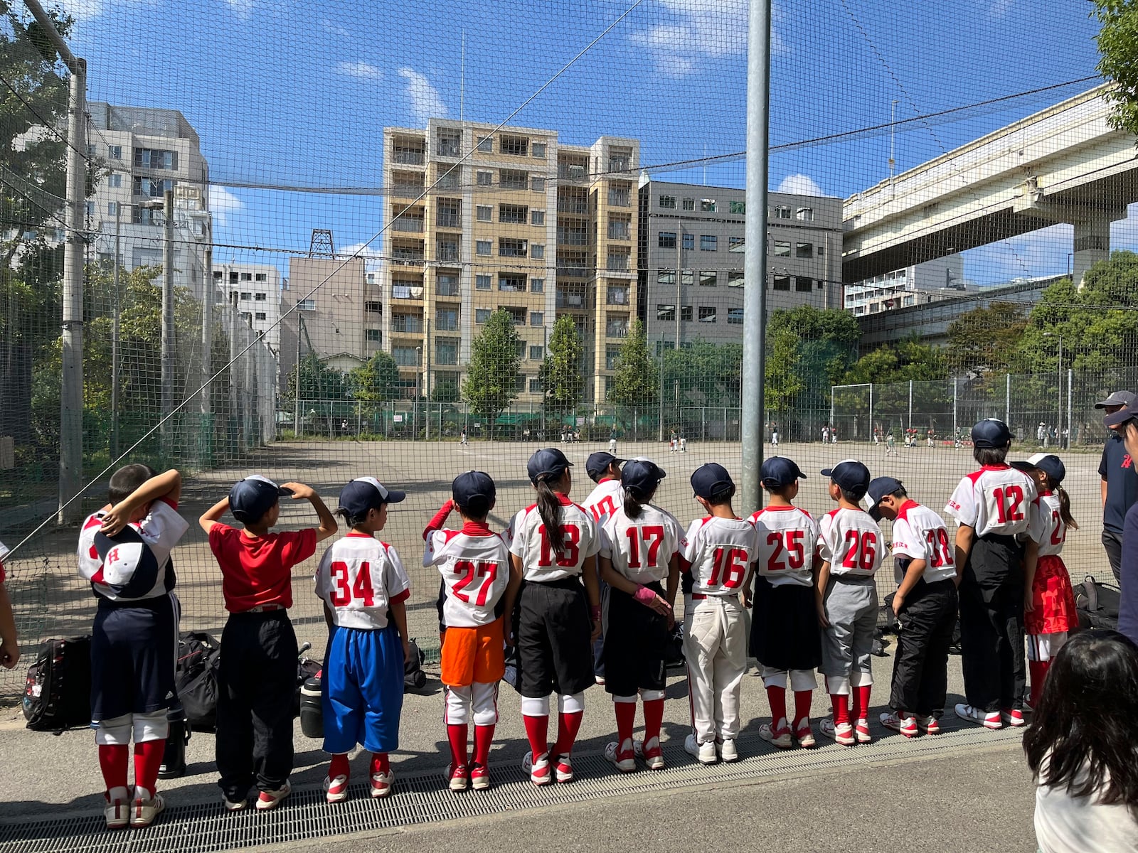 The Fukagawa Hawks youth baseball team stand in line after their practice Sunday, Oct. 13, 2024, in Tokyo, Japan. (AP Photo/Stephen Wade)