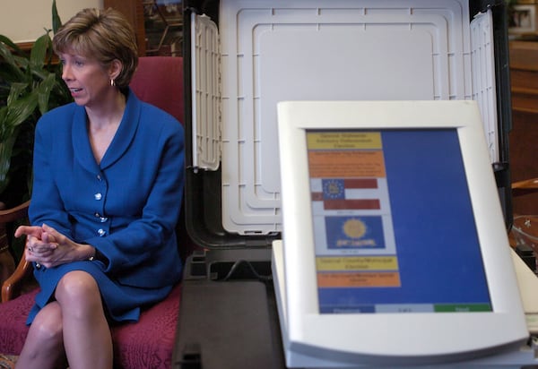 040105 - ATLANTA, GA -- Secretary of State Cathy Cox (cq) talks about Gerogia's new touch-screen voting machines, one of which is seen at right. (BEN GRAY/AJC staff)