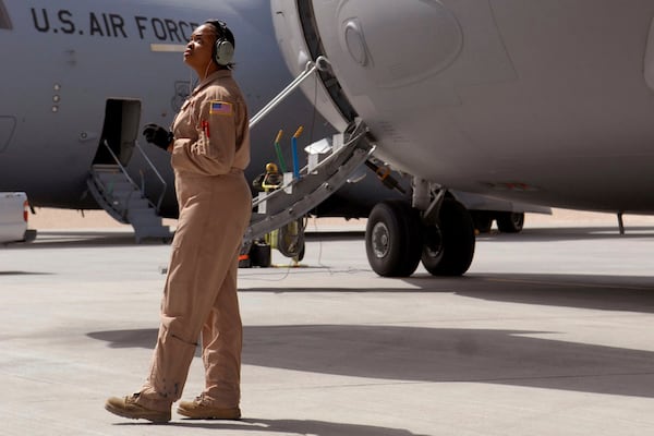 In this image provided by the U.S. Air Force, Staff Sgt. Krysteena Scales, a 816th Expeditionary Airlift Squadron Flying Crew Chief, performs pre-flight checks before departing on a mission in a C-17 Globemaster III, March 19, 2009, at an undisclosed location in Southwest Asia. (Senior Airman Andrew Satran/U.S. Air Force via AP)