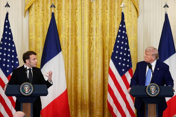 President Donald Trump, right, listens as France's President Emmanuel Macron speaks during a joint press conference in the East Room of the White House in Washington, Monday, Feb. 24, 2025. (Ludovic Marin/Pool via AP)