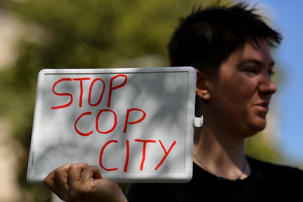 A protester holds a sign against a proposed public safety training center during the Justice for Tortuguita Rally at Liberty Plaza across from the Georgia Capitol on Saturday, March 25, 2023, in Atlanta. Activist Manuel Tortuguita Terán was killed by law enforcement authorities in January near the planned site of the training center. (Hyosub Shin / Hyosub.Shin@ajc.com)