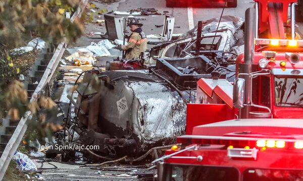 DeKalb County hazmat crews work to clean up spilled propane after a crash on I-85 North at Pleasantdale Road.