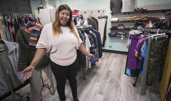 Dionysia Ambrose, program coordination for Wellspring Living Youth Academy, shows off the clothing boutique the nonprofit organization runs at Phoenix Academy. Atlanta Public Schools merged its alternative high school programs into the Phoenix Academy which launched this school year. BOB ANDRES / ROBERT.ANDRES@AJC.COM