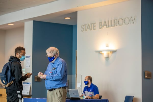 08/24/2020 - Atlanta, Georgia - Georgia State University Assistant Director of Academic Advisement Kenneth Meier  (second from left) assist Georgia State University undergrad David Cardwell III (left) at the student center during the first day of classes at Georgia State University in Atlanta, Monday, August 24, 2020. (ALYSSA POINTER / ALYSSA.POINTER@AJC.COM)