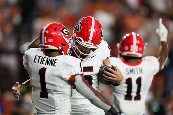 Georgia quarterback Carson Beck (15) and Georgia running back Trevor Etienne (1) celebrate as time expires during their 30-15 win against Texas at Darrel K Royal Texas Memorial Stadium, Saturday, October 19, 2024, in Austin, Tx. (Jason Getz / AJC)

