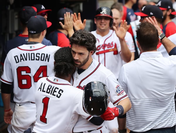 Braves infielder Dansby Swanson gets a hug from Ozzie Albies in the dugout after hitting a two-run home run against the Washington Nationals during the sixth inning Thursday, June 3, 2021, in Atlanta.  (Curtis Compton / Curtis.Compton@ajc.com)