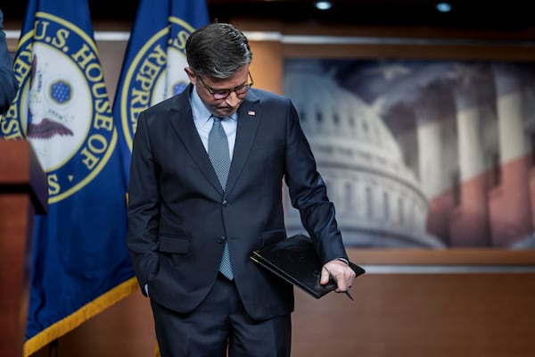 U.S. House Speaker Mike Johnson pauses before talking to reporters about  a spending bill at the Capitol on Tuesday.