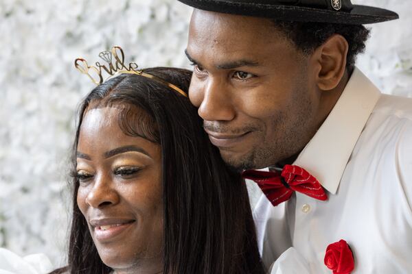 (L-R) Newlyweds Lakiela and Antonio Fleetwood take a photo at a photo booth after getting married in Courtroom 9G of the Fulton County Courthouse in Atlanta on Valentine’s Day, Tuesday, February 14, 2023. (Arvin Temkar / arvin.temkar@ajc.com)