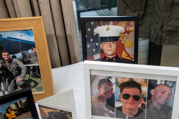 FILE - Photographs of Marine Cpl. Spencer R. Collart and his fellow marines, Capt. Eleanor V. LeBeau, bottom left, and Maj. Tobin J. Lewis, bottom right, are seen at the home of his parents in Arlington, Va., June 19, 2024. Collart, 21, was killed along with the two Marines when the MV-22B Osprey aircraft they were on crashed during drills on a north Australian island on Aug. 27, 2023. (AP Photo/Rod Lamkey, Jr.)