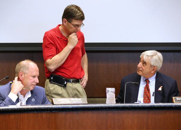 Councilman Johnny Walker (from left), councilman Philip Goldstein and Mayor Steve “Thunder” Tumlin at a council meeting earlier this year. Walker and Tumlin are supporting changes that would enable Janet Cosper to collect her husband’s pension. CURTIS COMPTON / CCOMPTON@AJC.COM