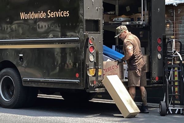 FILE - A United Parcel Service driver sorts his deliveries, on New York's Upper West Side, on July 15, 2023. (AP Photo/Richard Drew, File)