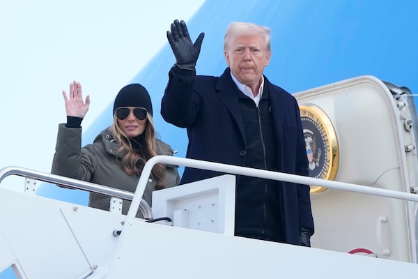 President Donald Trump and first lady Melania Trump wave as they board Air Force One, Friday, Jan. 24, 2025, at Joint Base Andrews, Md., for a trip to North Carolina and California. (AP Photo/Mark Schiefelbein)