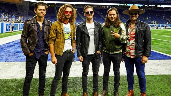 FILE - This Sept. 10, 2018 file photo shows members of the band LANCO on the field before a NFL football game between the Detroit Lions and the New York Jets in Detroit. The Academy of Country Music named LANCO as best new group of the year. The group of five released their first album “Hallelujah Nights” last year on Arista Nashville. 