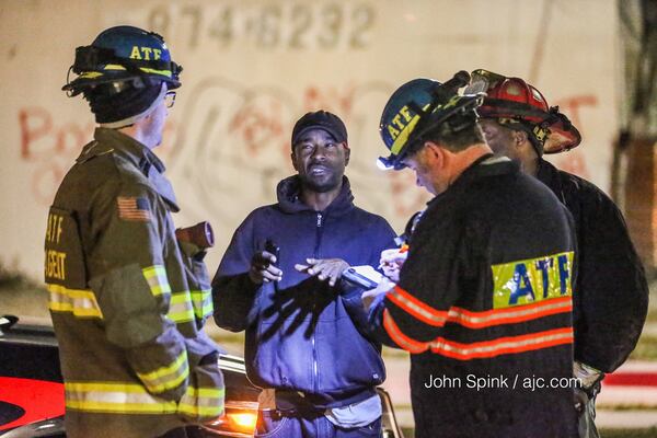 Authorities talked to witnesses after a fire in northwest Atlanta. JOHN SPINK / JSPINK@AJC.COM