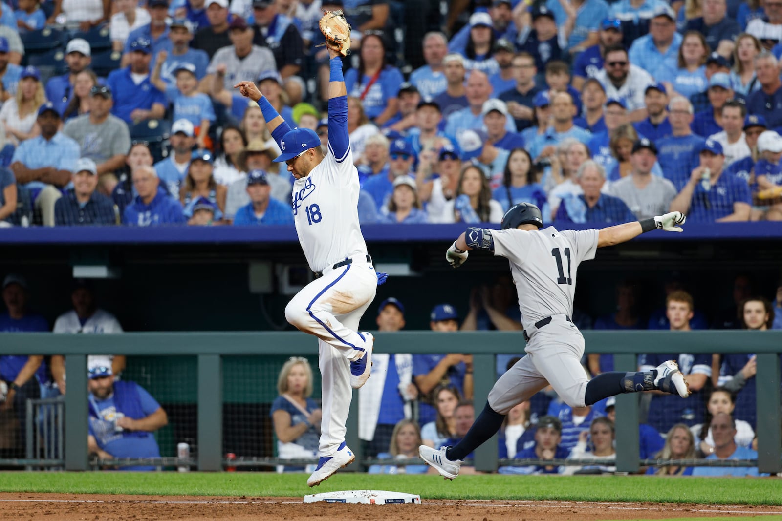 New York Yankees' Anthony Volpe (11) grounds out as Kansas City Royals first baseman Yuli Gurriel (18) handles the throw at first during the third inning in Game 3 of an American League Division baseball playoff series Wednesday, Oct. 9, 2024, in Kansas City, Mo. (AP Photo/Colin Braley)