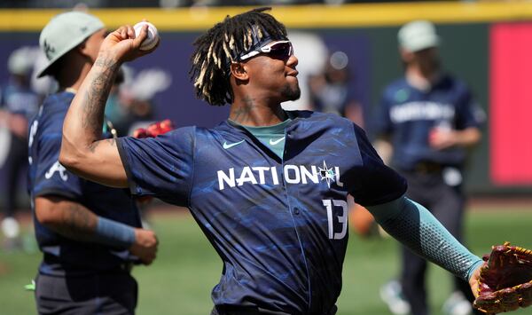 Ronald Acuña Jr. prepares to throw while warming up prior to the MLB All-Star baseball game in Seattle, Tuesday, July 11, 2023. (AP Photo/Ted S. Warren)