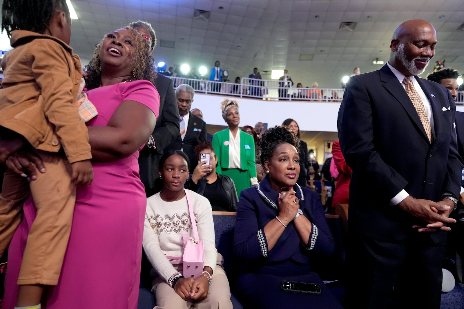 Attendees listen as Stevie Wonder performs "Redemption Song" during a church service and early vote event with Democratic presidential nominee Vice President Kamala Harris at Divine Faith Ministries International, Sunday, Oct. 20, 2024, in Jonesboro, Ga. (AP Photo/Jacquelyn Martin)