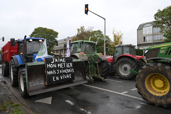 Farmers drive their tractors during a rally against the EU-Mercosur trade agreement, Monday, Nov. 18, 2024 in Beauvais, northern France. Poster reads: I love my job and would like to live on it.(AP Photo/Matthieu Mirville)