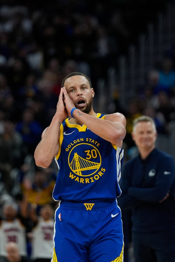 Golden State Warriors guard Stephen Curry reacts after making a 3-point basket during the second half of an NBA basketball game against the Dallas Mavericks, Sunday, Feb. 23, 2025, in San Francisco. (AP Photo/Godofredo A. Vásquez)