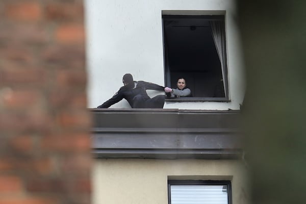 A law enforcement officer works to gather fragments of a downed Ukrainian drone at a building in western Moscow, Russia, Friday, March 14, 2025. (AP Photo)