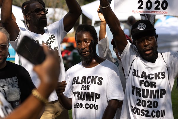 Trump supporters dance near the Rice Street entrance of the Fulton County Jail in Atlanta on Thursday, August 24, 2023, the day Donald Trump is expected to surrender following his indictment with 18 others. (Arvin Temkar / arvin.temkar@ajc.com)