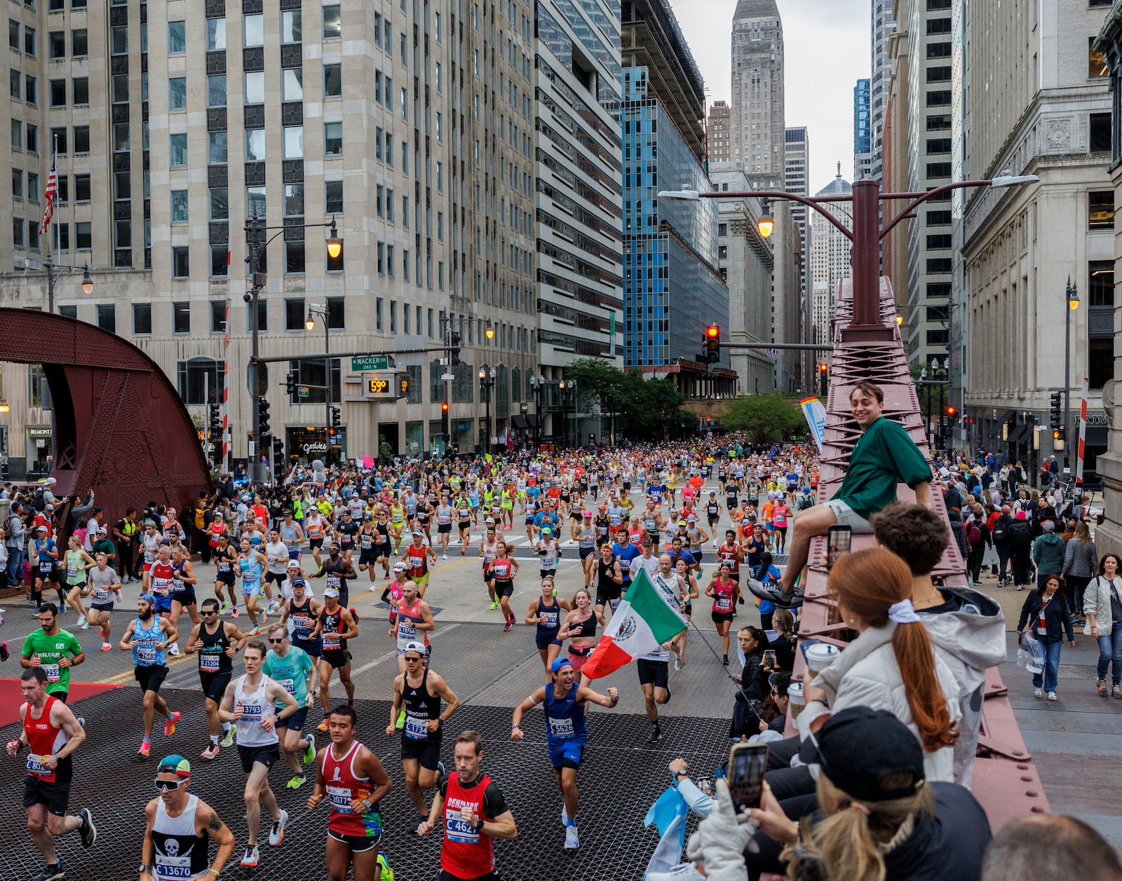 Runners cross the LaSalle Street bridge during the Chicago Marathon, Sunday, Oct. 13, 2024, in Chicago. (Armando L. Sanchez/Chicago Tribune via AP)