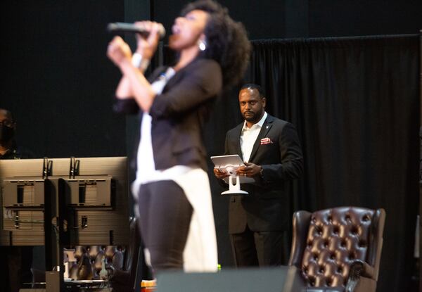 Pastor Jesse Curney III of the New Mercies Christian Church in Lilburn watches Praise and Worship singer April Thompson perform during the church service Sunday, August 2, 2020.  STEVE SCHAEFER FOR THE ATLANTA JOURNAL-CONSTITUTION