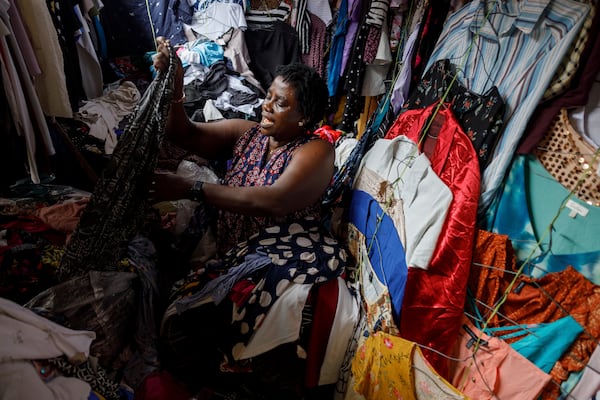 A second-hand retailer sorts out clothes at Kantamanto, one of the world's largest second-hand clothing markets, in Accra, Ghana, Saturday, Oct. 26, 2024. (AP Photo/Misper Apawu)