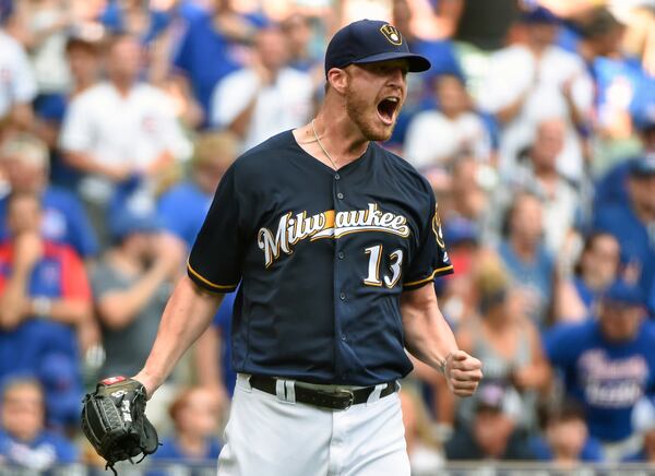 Milwaukee Brewers pitcher Will Smith reacts after giving up a double to Chicago Cubs' Tommy La Stella during the seventh inning of a baseball game Sunday, July 24, 2016, in Milwaukee. (AP Photo/Benny Sieu)